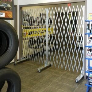 Heavy duty portable folding gates in use in an auto store